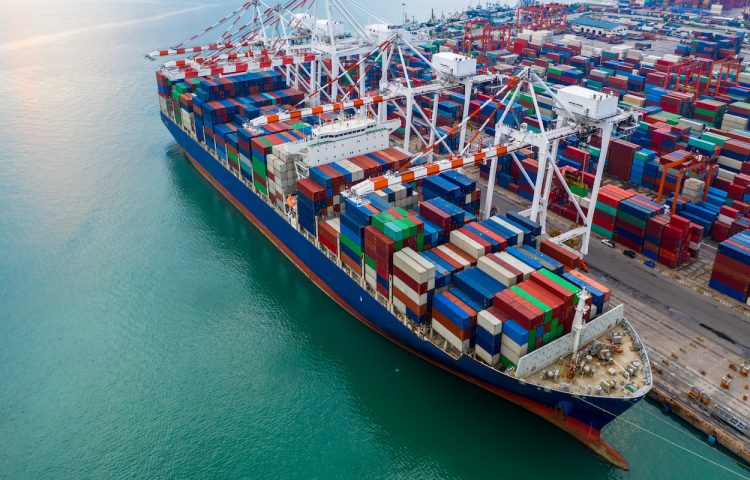 Aerial view port shipping, Container ship at port with crane port, Container ship carrying container import and export business logistic and transportation, Cargo freight shipping import export company.